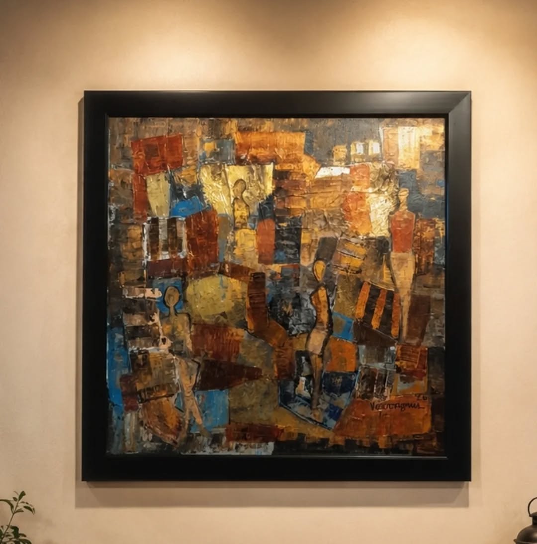 Abstract painting with geometric patterns in a black frame on a beige wall.