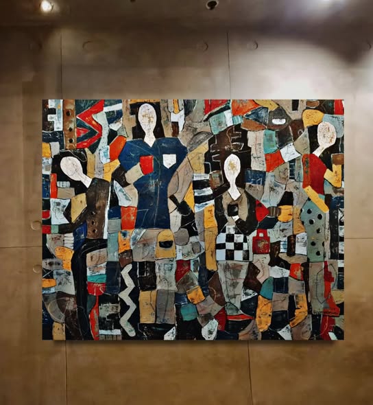 Abstract artwork with geometric shapes and colors on a beige wall.