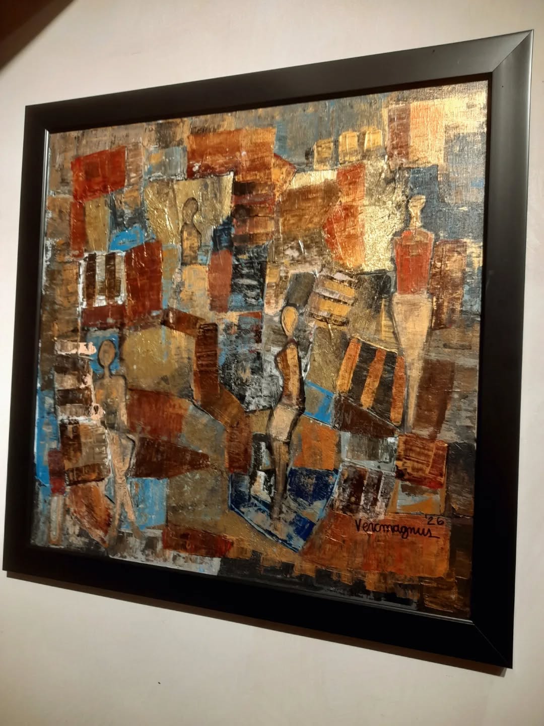 Framed abstract artwork with geometric shapes and figures on a white wall