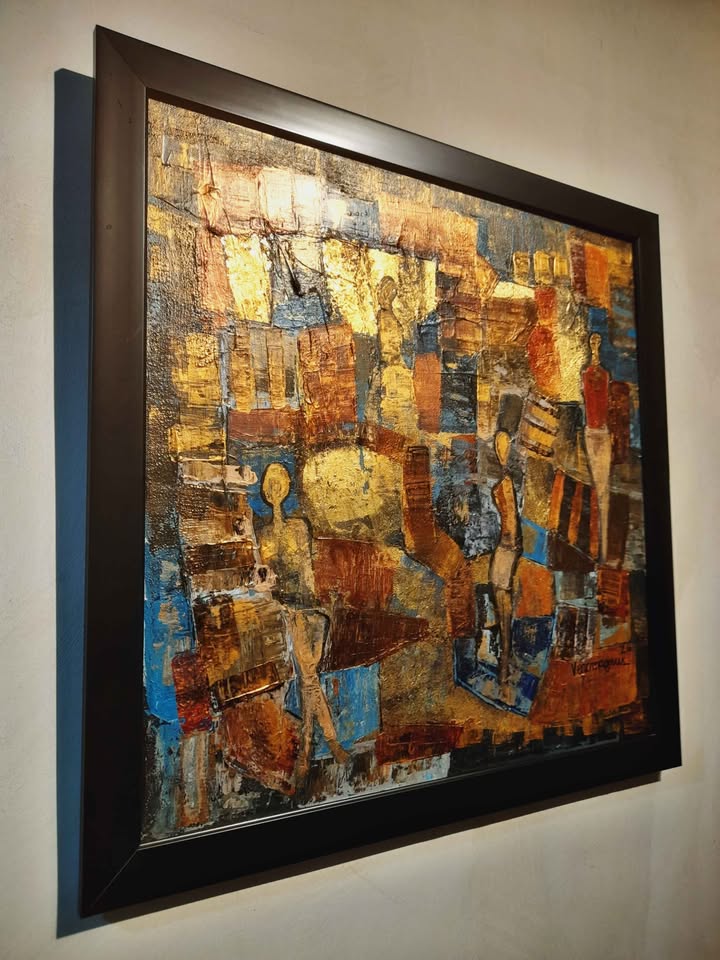 Abstract artwork in a black frame on a wall