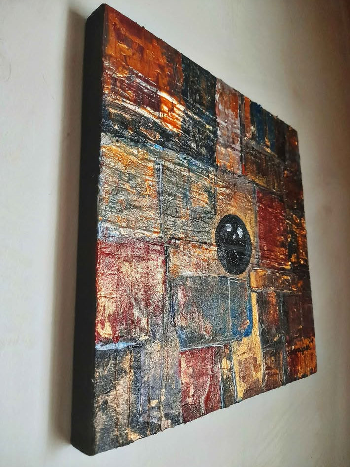 Abstract patchwork artwork on a white wall