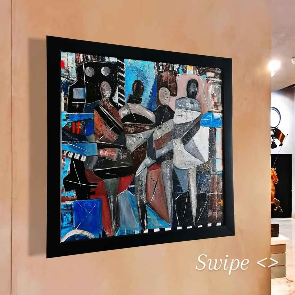 Abstract artwork in a black frame on a beige wall